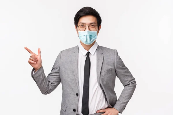 Waist-up portrait of handsome professional male entrepreneur showing new employee office, pointing finger left, look at chat, smiling at camera pleased and proud, standing white background — Stock Photo, Image