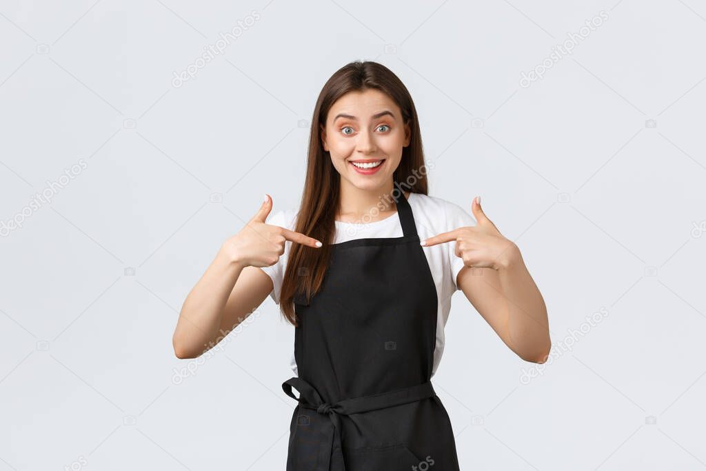 Small business, employees and coffee shop concept. Excited happy barista pointing at herself, asking promotion. Cheerful friendly cafe worker volunteer, bragging about personal achievement