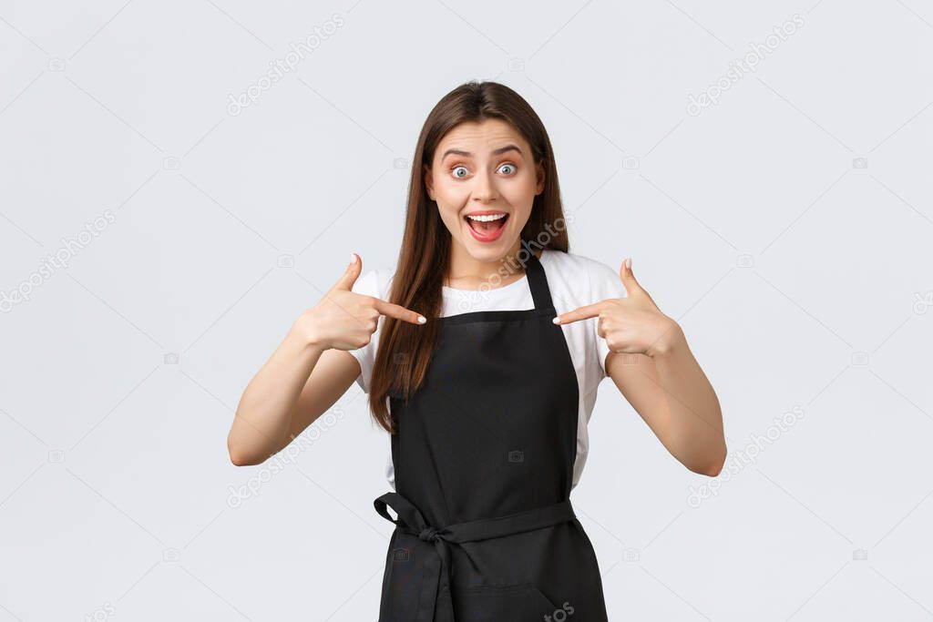 Small business, employees and coffee shop concept. Excited happy barista pointing at herself, asking promotion. Cheerful friendly cafe worker volunteer, bragging about personal achievement