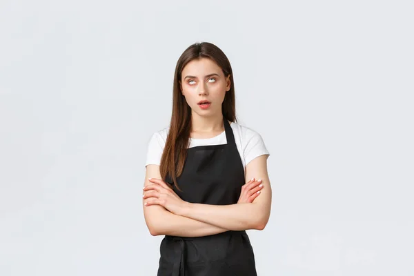 Grocery store employees, small business and coffee shops concept. Annoyed and pissed-off barista do eye roll and sighing irritated, fed up with uninteresting conversation — Stok fotoğraf