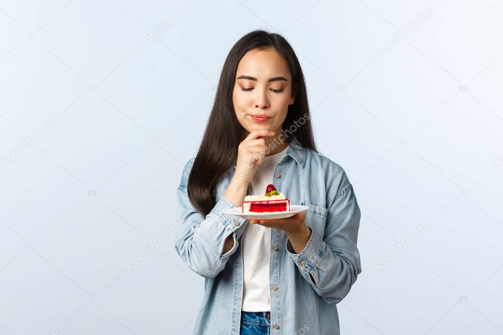Social distancing lifestyle, covid-19 pandemic, celebrating holidays during coronavirus concept. Thoughtful serious-looking b-day girl thinking focused what wish make on birthday