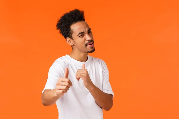My man awesome. Cheeky and cool african-american hipster guy feeling proud of friend, praising someone, pointing camera encourage all good, satisfied, congratulate person, standing orange background — Stock Photo, Image