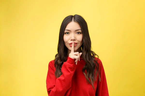 Junge Frau über gelbe Wand zeigt Zeichen der Stille Geste legt Finger in den Mund — Stockfoto