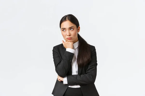 Bored and annoyed female entrepreneur looking unamused away while sitting boring meeting, attend uninteresting office gathering, standing white background dying boredom — Stock Photo, Image