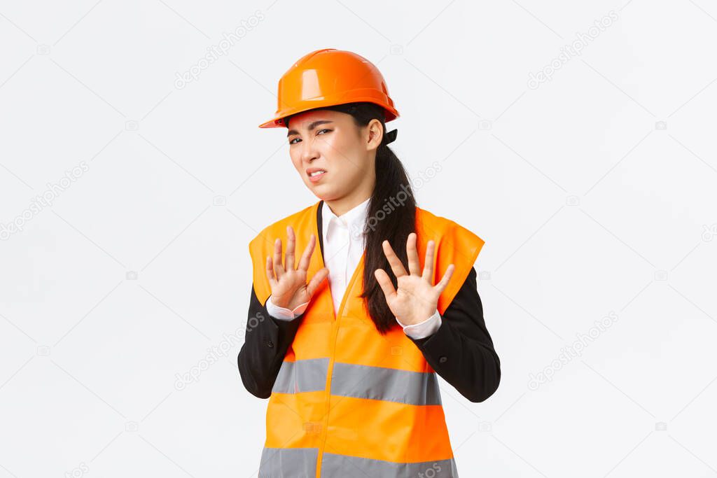 Reluctant and displeased asian female engineer refuse listen, showing stop, prohibit gesture, rejecting bothering offer, annoyed with clingy project manager, white background