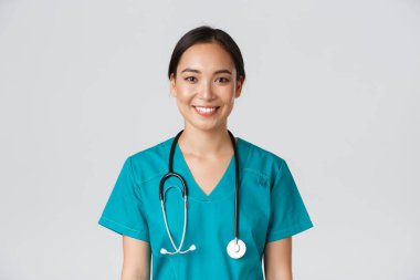 Sağlık çalışanları, virüsü önleme, karantina kampanyası konsepti. Gülümseyen hoş Asyalı kadın hemşire, önlüklü doktor neşeli görünüyor, hasta dinliyor, beyaz bir geçmişi var.