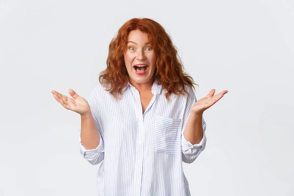 Lifestyle, emotions and people concept. Portrait of happy, excited redhead woman triumphing, raising hands up, clapping from amazement, receive surprising awesome news — Stock Photo, Image