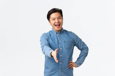 Dost canlısı gülümseyen asyalı adam seninle tanıştığıma memnun oldum diyor, el sıkışmak için elini uzat, birini selamla, ofise hoş geldin, kendini tanıt, beyaz arka plan