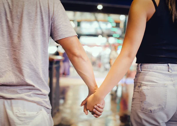 Cropped Image Of Couple Holding Hand And Walking Outdoors In Shopping Mall Two Girl Stock Photo