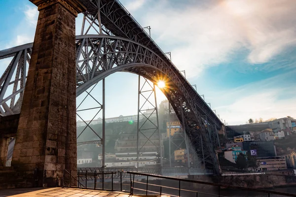 Dom Luis I Bridge in the morning with sun lights, Porto, Portugal. The bridge is a popular tourist spot as it offers an amazing view over the city.