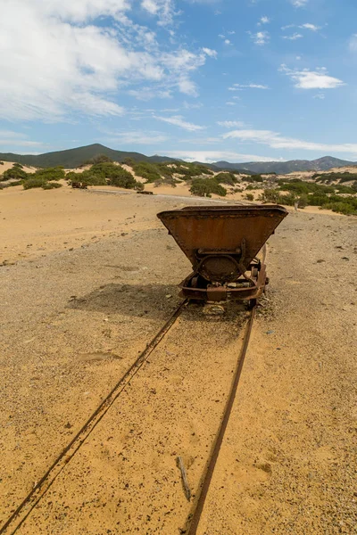Rusty mine cart on abandoned tracks. Ingortosu Arbus, Sardinia, Italy