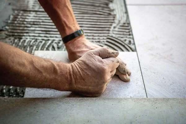 Tile installation with glue on concrete floor — Stock Photo, Image