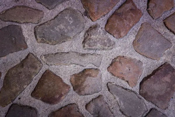 Ancient wall made with black and beige stones — Stock Photo, Image