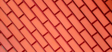 Kırmızı tuğla duvar çapraz deseni temsil ediyor.