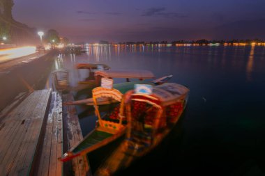 Günbatımından sonra Dal Gölü, Srinagar, Jammu ve Kashmir 'de yüzen yüzen yüzen yüzen yüzen yüzen yüzen yüzen tekneler..