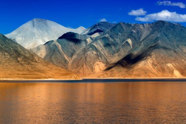 Arka planda mavi gökyüzü olan Pangong Tso Gölü 'ndeki dağların yansıması. Ladakh 'ta büyük bir göl olup Hindistan' dan Tibet 'e kadar 134 km uzunluğundadır. Leh, Ladakh, Jammu ve Kashmir, Hindistan