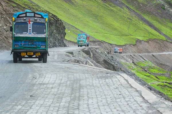 LEH, INDIA - SEPTEMBER 1, 2014 : Trucks carrying goods are passing through Zojila Pass, a high mountain pass between Srinagar and Leh at 11575 ft, 9 Km stretch. Highest Indian National Highway.