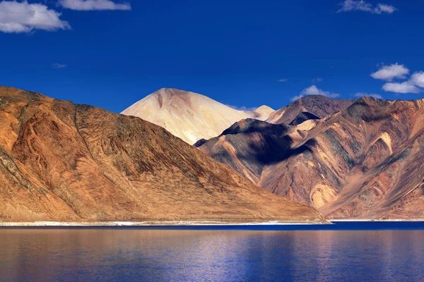 Pangong tso 'daki dağların yansıması (Göl) ve arka planda mavi gökyüzü. Ladakh 'ta büyük bir göl olup Hindistan' dan Tibet 'e kadar 134 km uzunluğundadır. Leh, Ladakh, Jammu ve Kashmir, Hindistan