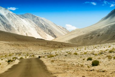 Güzel kayalık dağlara doğru beton bir yol Himalaya, Leh, Ladakh, Jammu ve Kashmir tepeleri olan mavi gökyüzü, Hindistan