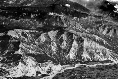 Himalaya 'nın Ladakh dağlarının havadan görünüşü dağ zirveleri ve altından akan İndus nehri olan yeşil bir manzara. Ladakh, Jammu ve Kashmir, Hindistan. Siyah ve beyaz resim.