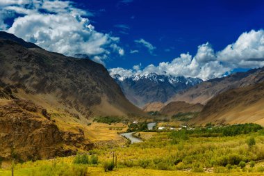 Arka planda mavi bulutlu gökyüzü, yeşil vadi, Ladakh, Jammu ve Kashmir 'in Rocky manzarası, Hindistan