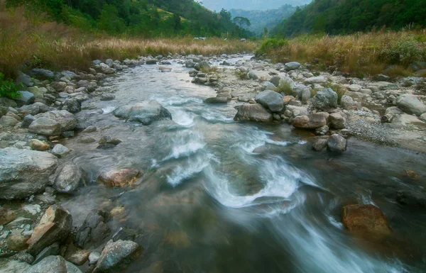 Beautiful Reshi River water flowing through stones and rocks at dawn, Sikkim, India. Reshi is one of the most famous rivers of Sikkim flowing through the state and serving water to many local people.