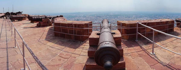 Ancient cannons stationed and aimed at horizon for defensing against past enemies of Jodhpur city, preserved now on the rooftop of Mehrangarh fort. Tourist attraction of Rajasthan.