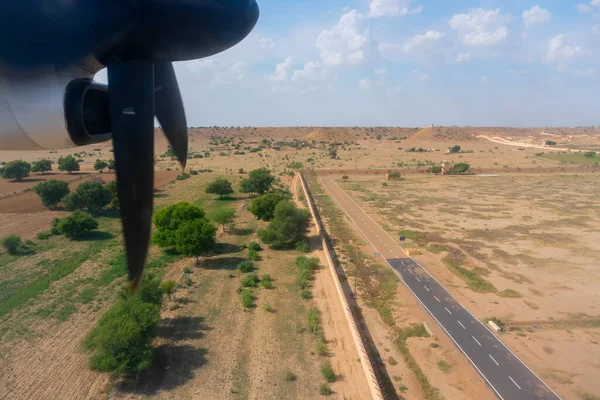View of Thar desert from an aeroplane, Rajasthan, India. The propellers, the runway of Jaisalmer airport and thar desert in the frame.