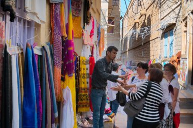 Jaisalmer, Rajasthan, Hindistan - 13 Ekim 2019: Renkli kadın giysileri Jaisalmer Kalesi 'nin içindeki pazar yerindeki kadın yabancılara sabah satılıyor. Popüler UNESCO dünya mirası sahası.