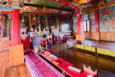 Rinchenpong, Sikkim, Hindistan - 17 Ekim 2016: Rinchenpong manastırı içinde duvarlarında süslü duvar resimleri olan genç bir Lama.