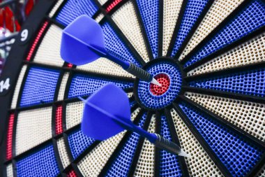 Dart, duvara sabitlenmiş dairesel bir dart tahtasına atılan küçük ok / okların atıldığı bir spordur. Bir dart hedefi tam ortasından vurmayı başardı. Diğeri başarısız oldu. Başarı hikayesi. Kavramsal.