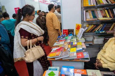 KOLKATA, INDIA - 9 Şubat 2018: Kolkata kitap fuarında kitap arayan güzel Hintli kadın müşteri. Dünya 'nın en büyük, en katılımcı ve en ünlü ticaret dışı kitap fuarıdır..