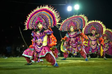 BAMNIA, PURULIA, WEST BENGAL , INDIA - DECEMBER 23RD 2015 : Four dancers performing at Chhau Dance festival. It is a very popular Indian tribal martial dance performed at night amongst spectators. clipart