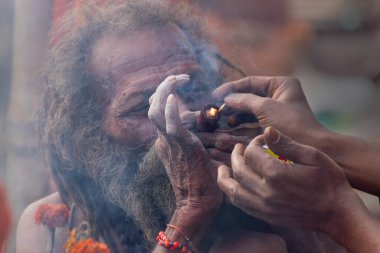 BABUGHAT, KOLKATA, Batı BENGAL / INDIA - 11 HAZİRAN 2015: Esrar içen Hindu Sadhu, yerel olarak Ganja, bir tür kanabis sativa .