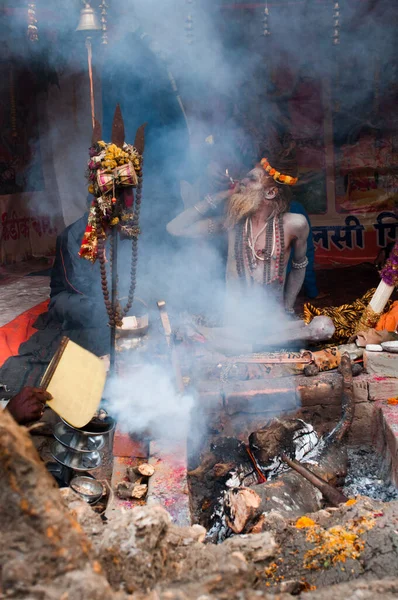 BABUGHAT, KOLKATA, WEST BENGAL / INDIA - 9TH JANUARY 2013 : A Sadhu (Hindu Saint) smokes on 9th January, 2013 at Babughat, Kolkata. Every year many Sadhus from all over India reaches Babughat on their way to reach Gangasagar (Sagar) to bathe there. G