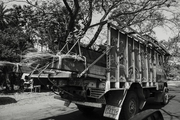 HOWRAH, WEST BENGAL, INDIA - FEBRUARY 24TH, 2018 : A goods carriage truck is carrying goods on the highway in daytime. Black and white image.