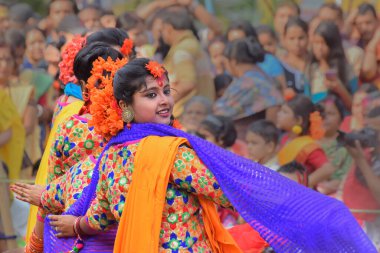 KOLKATA, INDIA - 12 Mart 2017: Sari (geleneksel Hint elbisesi) giymiş kız dansçılar ve Palash çiçekleri (Butea monosperma) makyaj, Dol (Bengalce) veya Holi (Hintçe) festivalinde dans.