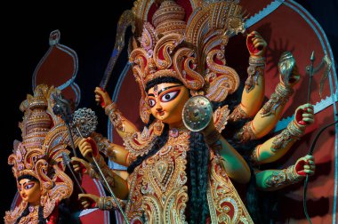 Goddess Durga idol , Durga Puja festival at night. Shot under colored light at Howrah, West Bengal, India. Biggest festival of Hinduism , celebrated all over the world. clipart