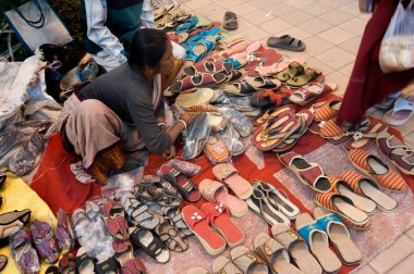 KOLKATA, Batı BENGAL, INDIA - 12 Ocak 2014: Asya 'nın en büyük el sanatları fuarı olan Kolkata' da el sanatları fuarında ayakkabı satan tanımlanamayan kadın.