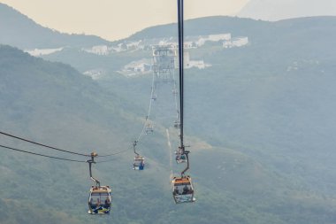 Lantau Island, Hong Kong - November 14, 2014: Beautiful view from Hong Kong cable cars, the popular public transportation from Tung Chung Station to Ngong Ping village, Lantau Island, Hong Kong. clipart