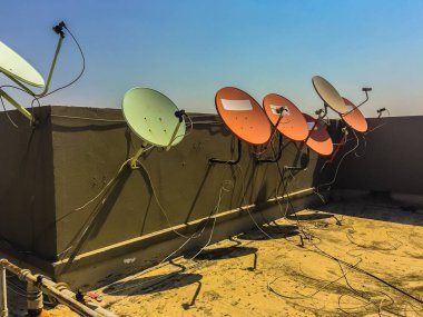 Eski kat mülkiyeti binanın beton güverte üst çatı katında eski çanak antenler