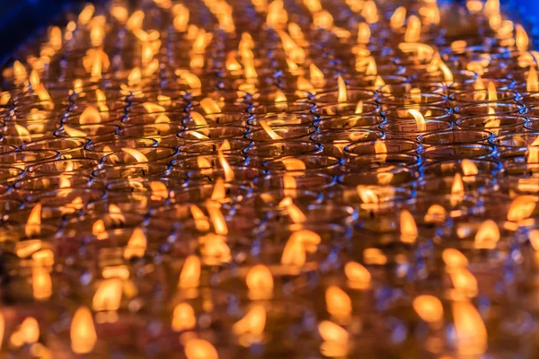 Orange candles in glasses from Chinese temple, Red candle is kindle a fire in glass at the Chinese temple, Prepare for Chinese new year. Shallow depth of field.