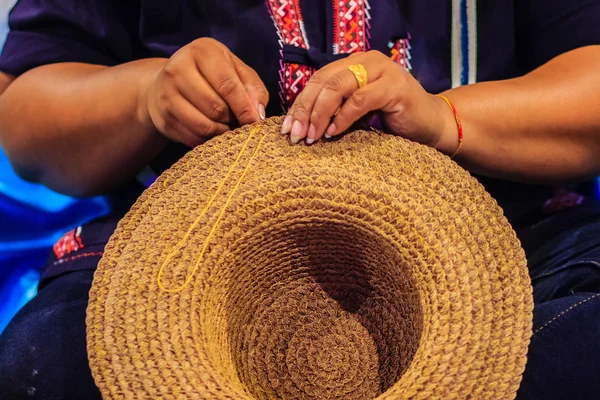 Geleneksel kurutulmuş muz dikiş el sanatları işçisi kadın bir el sanatları şapkaya köyleri bırakır. Ürün yerel Tayland köyü kuru muz yapraklarından yapılmış şapka