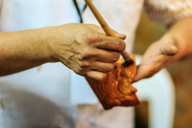 Tay heykeltıraş eller yukarıda hanuman kukla oyuncak Gece Pazarı'na adlı şaheseri boyama sırasında kapatın