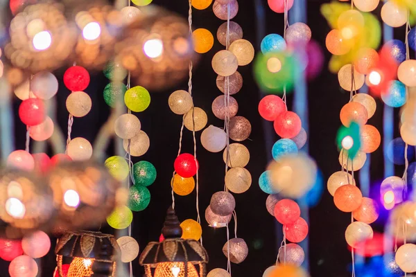 stock image Beautiful curtain line of LED lighting with bokeh at night. Abstract line of LED light bokeh defocused background. Colorful decorative LED lights for sale in the night market at Bangkok, Thailand.