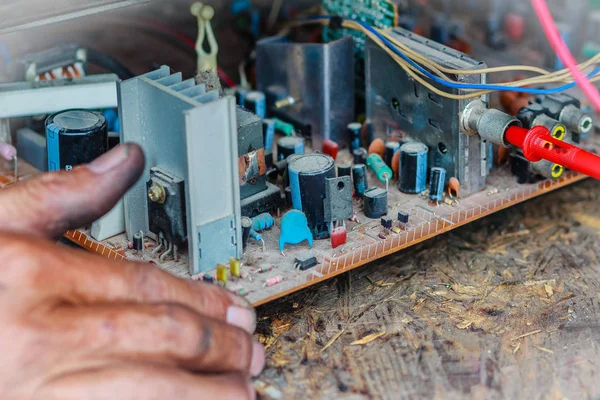 Electrician repairing a TV in old television repair shop