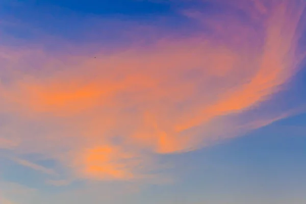 Red clouds on blue sky in twilight evening. Beautiful sunset sky with blue and red background. Dramatic colorful of dusk and dawn sky with blue sky and red clouds.