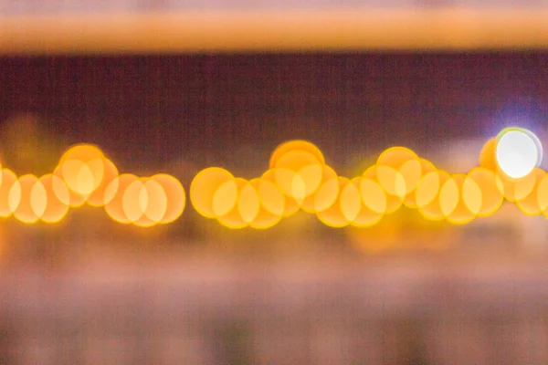 Abstract blur bokeh of Evening traffic jam on road in city. Out of focus lights from cars in a traffic jam. Defocused lights car traffic jam of a street road at night. Road traffic jam night,blur focus