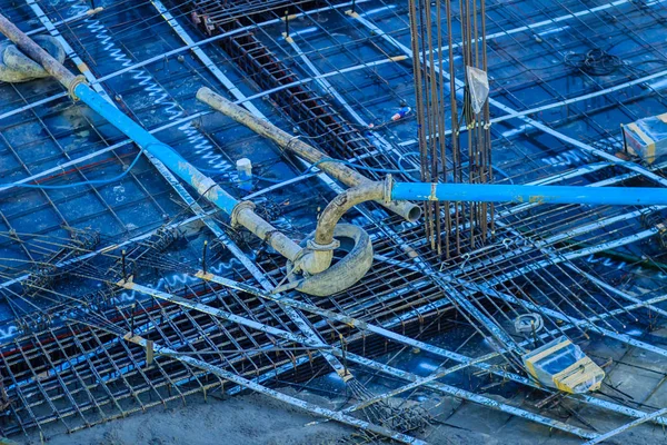Cleaned floor slab reinforcement bar with post tension cable tendon on steel form work at the construction site before concreting.