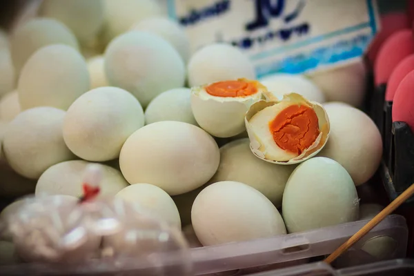 Salted duck eggs for sale in the fresh market. The preservation of duck eggs with salt. Yolk of salted eggs.